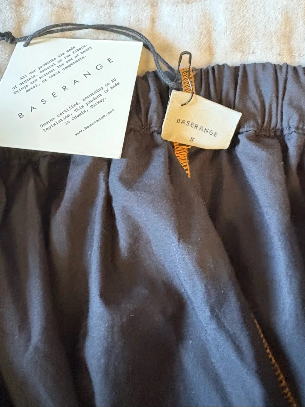 BASERANGE The Turn Skirt In Black Organic Cotton Contrast Stitch Twisted Seams